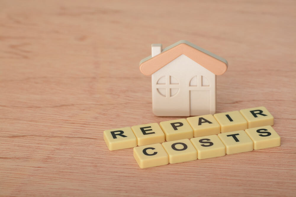 Home repair costs spelled out in Scrabble tiles.