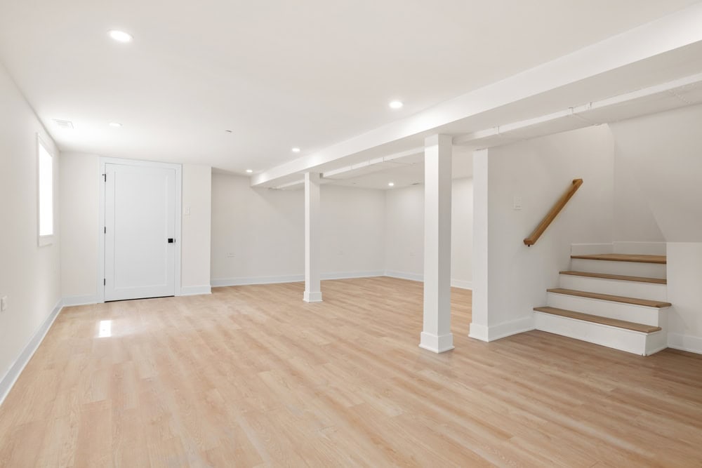 Bright and spacious basement with sleek hardwood floors and modern design.