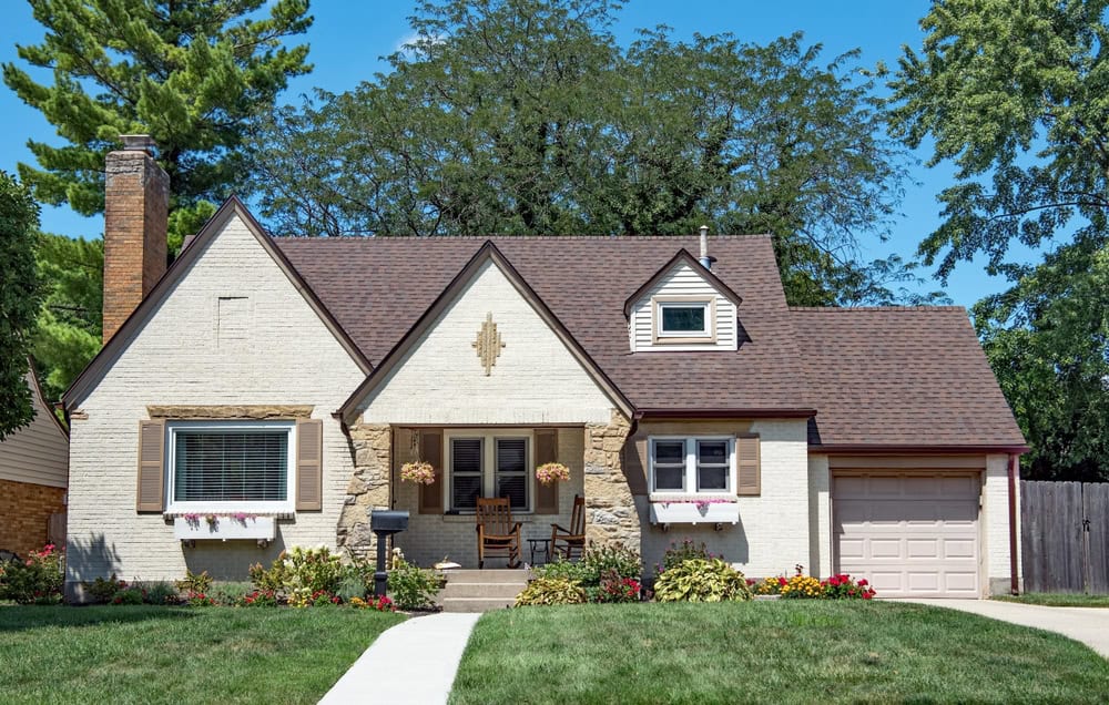 Charming suburban home with a well-kept garden, cozy front porch, and classic architectural details.