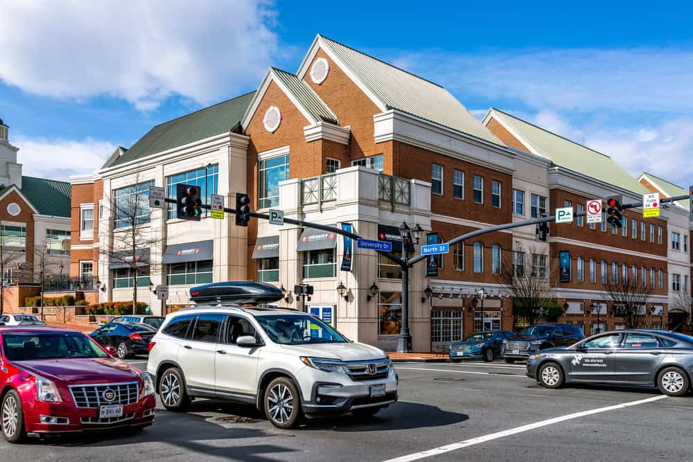 Busy intersection in front of a vibrant shopping center on University Drive.