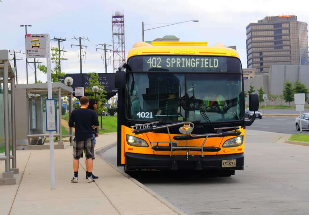 Route 402 to Springfield arrives at a bustling Virginia bus stop, ready to transport commuters through the heart of the city.