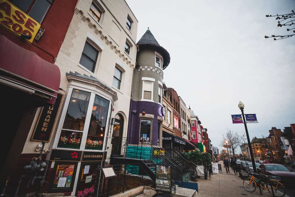 Vibrant streetscape in Washington, D.C.'s Adams Morgan neighborhood, buzzing with eclectic architecture, cozy eateries, and city charm.