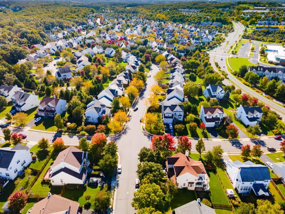 Aerial view of a vibrant suburban neighborhood with colorful autumn foliage.