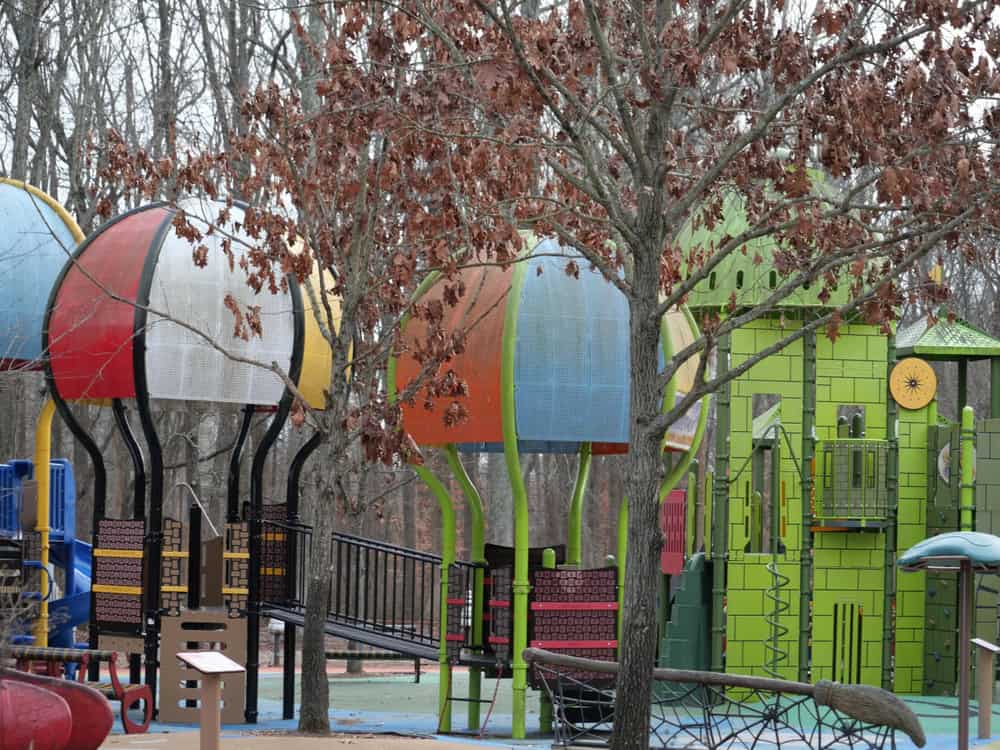 Watkin Regional Park - A whimsical playground filled with colorful hot air balloon-inspired play structures, surrounded by autumn trees.