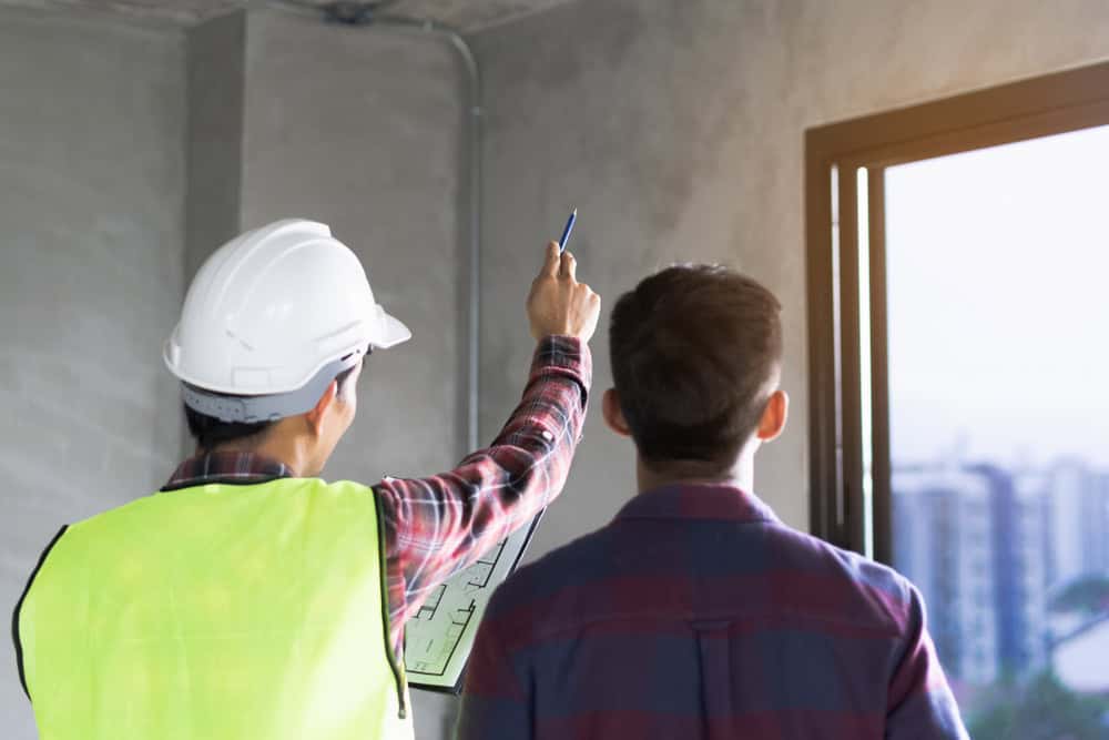 An inspector and a client review quality of the house