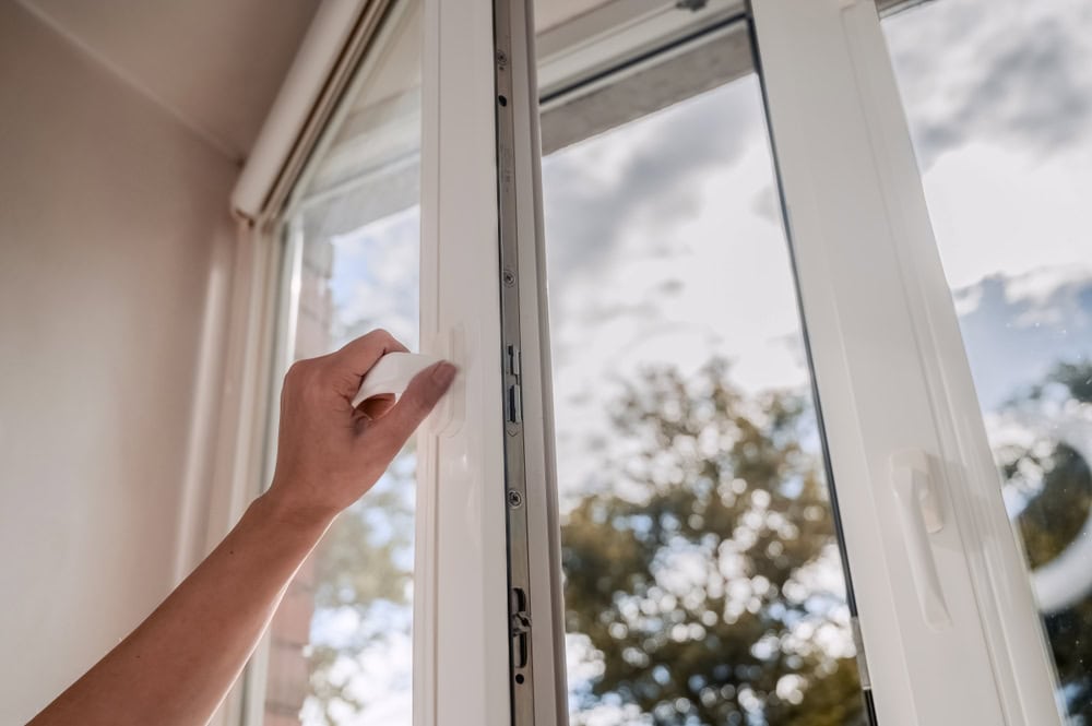 Opening the window to let in the fresh breeze and sunlight.