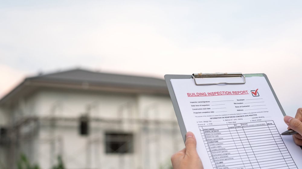 Conducting a thorough building inspection to ensure quality and safety standards are met.