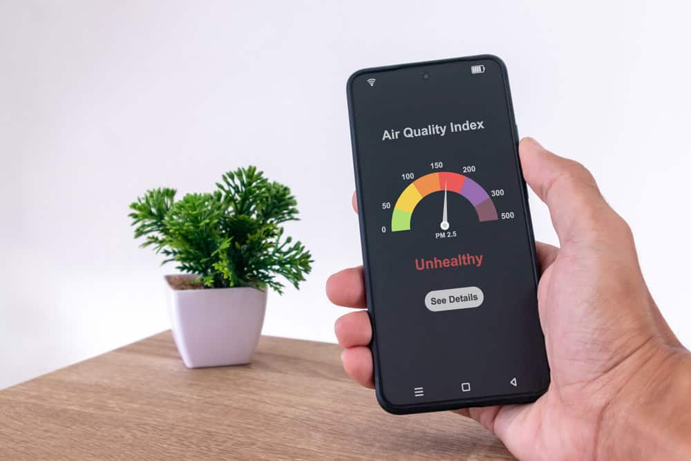 Bad air day: Checking unhealthy air quality on a phone.