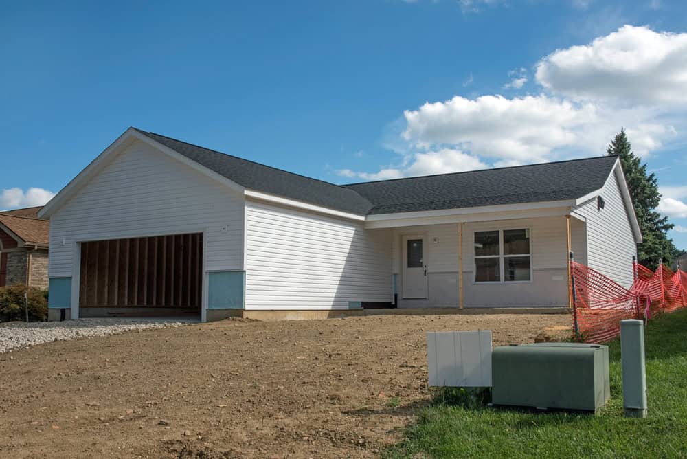 New home under construction with a spacious garage and modern design.