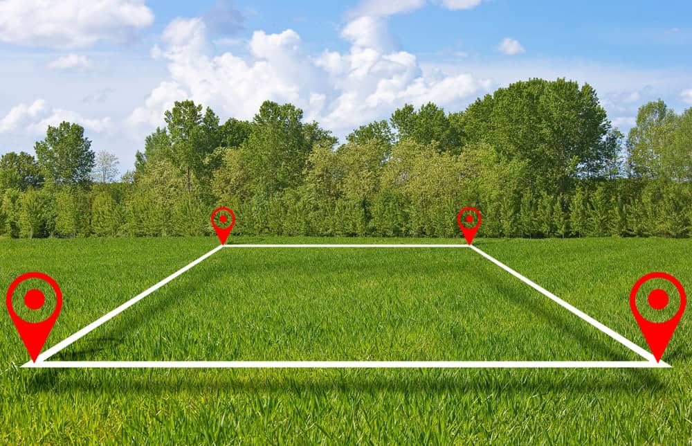 A serene green field marked with red location pins, ready for exploration or development.