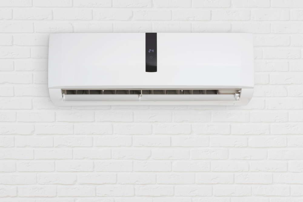 Stay cool with this sleek, modern air conditioner mounted on a pristine white brick wall.