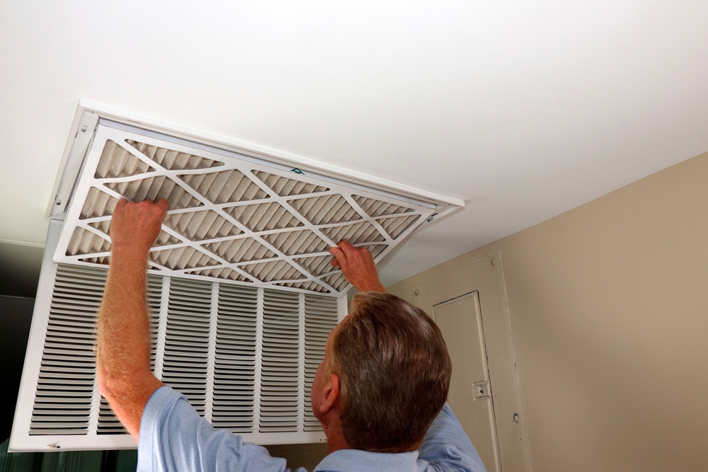 Changing the air filter in a home HVAC system for better air quality.