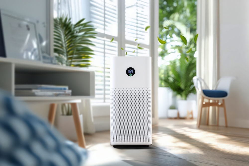 A modern air purifier enhancing the air quality in a bright, plant-filled living room.