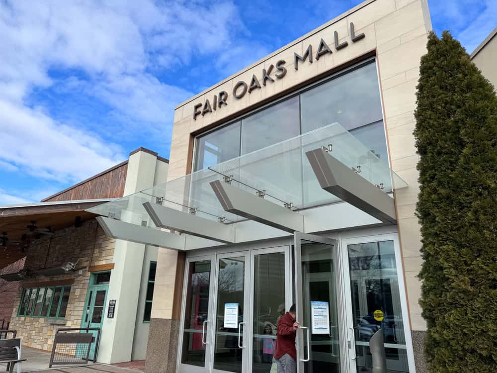 Fair Oaks Mall, with a glassy entrance and a tall evergreen.