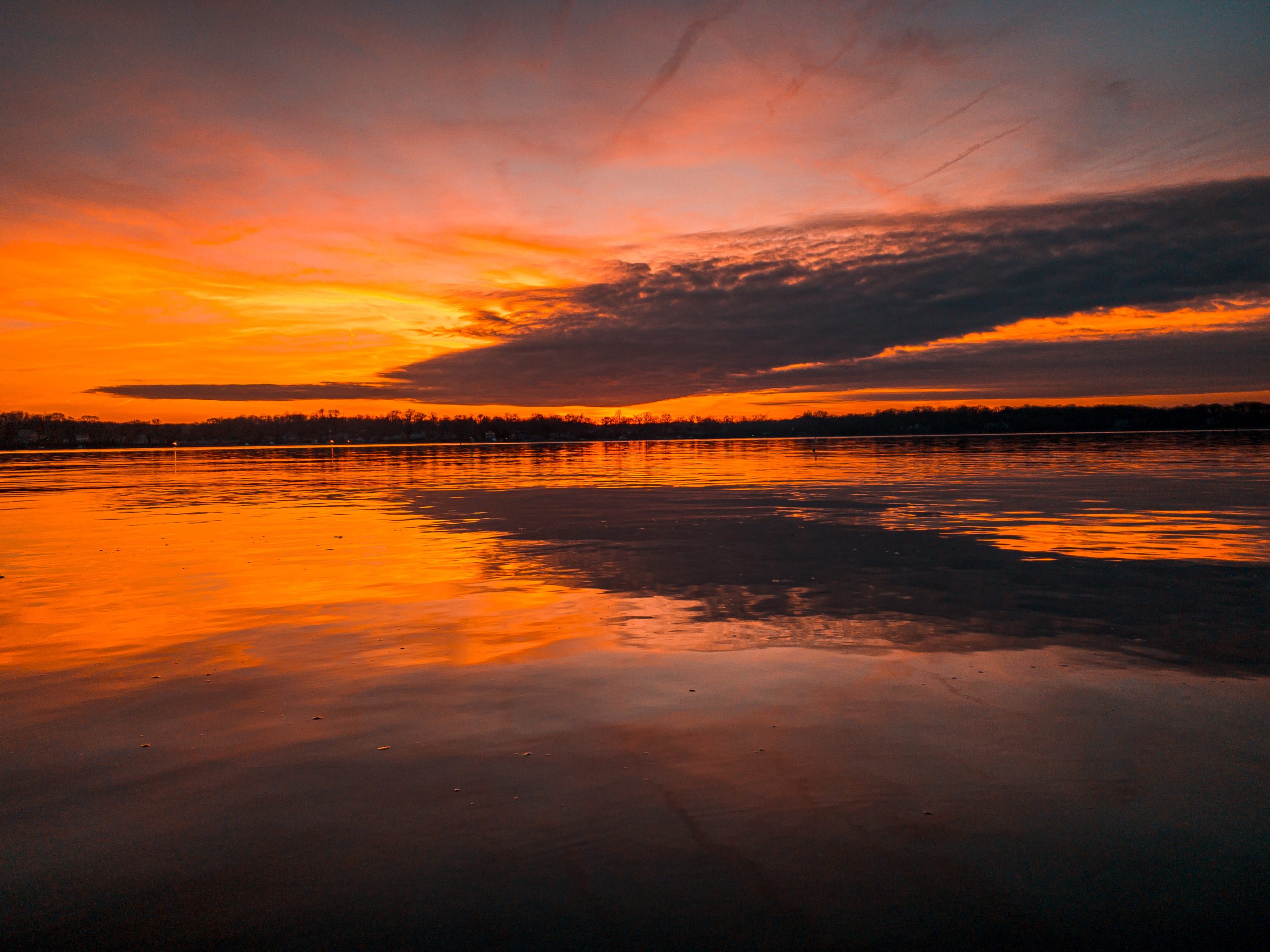 Golden Hour's Embrace: Fiery Skies Paint a Mesmerizing Reflection on Still Waters