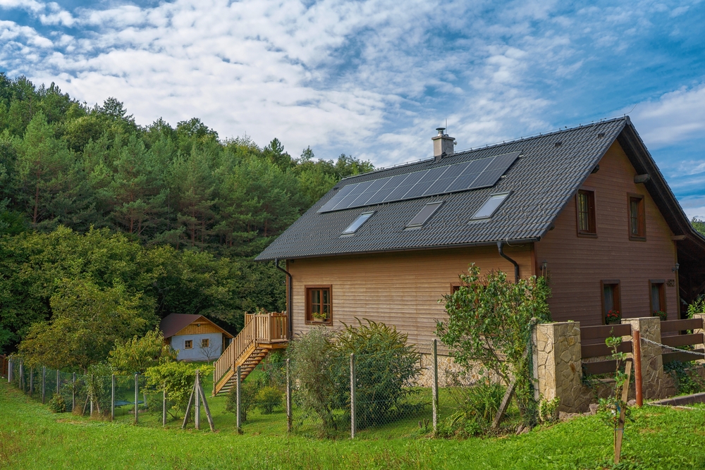 Eco-friendly countryside retreat with solar panels and lush greenery.