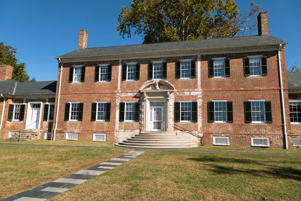 Historic mansion with classic brick architecture and a grand entrance.