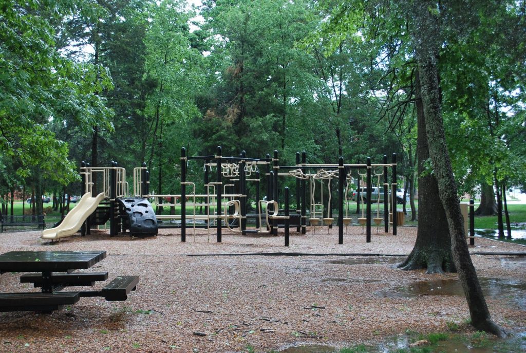 A playground sits empty after the rain, ready for fun.