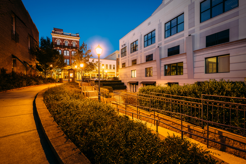 Charming urban stroll at dusk, with warm streetlights and historic architecture.