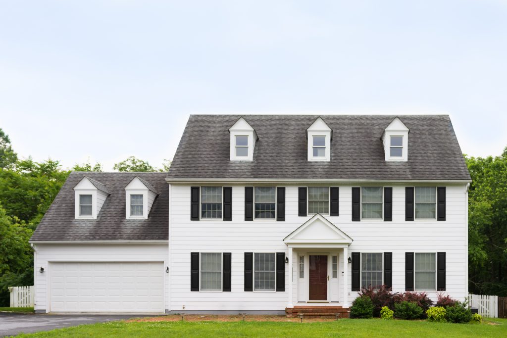 Charming colonial-style home with a spacious front yard and elegant black shutters in Stephenson, VA