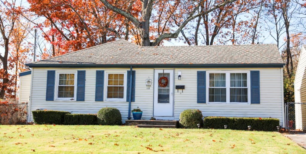 A cozy autumn home adorned with vibrant fall hues and a festive wreath.