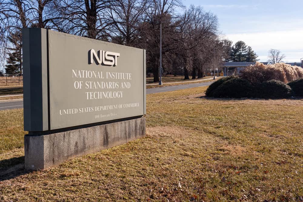 NIST sign welcomes visitors at the entrance to the National Institute of Standards and Technology campus in Gaithersburg, Maryland, on a winter's day.