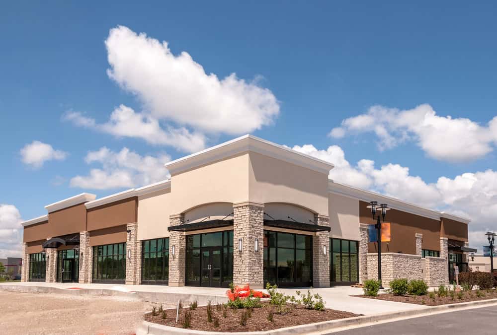 A modern commercial building with large windows, ready for new businesses to move in.