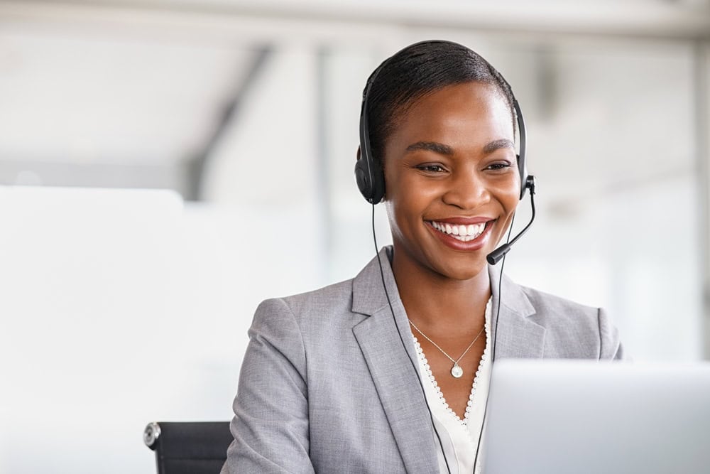 Smiling agent delivering excellent customer service.