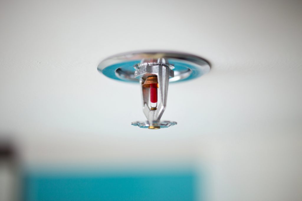 Close-up of a ceiling-mounted fire sprinkler, ready to protect with instant activation.