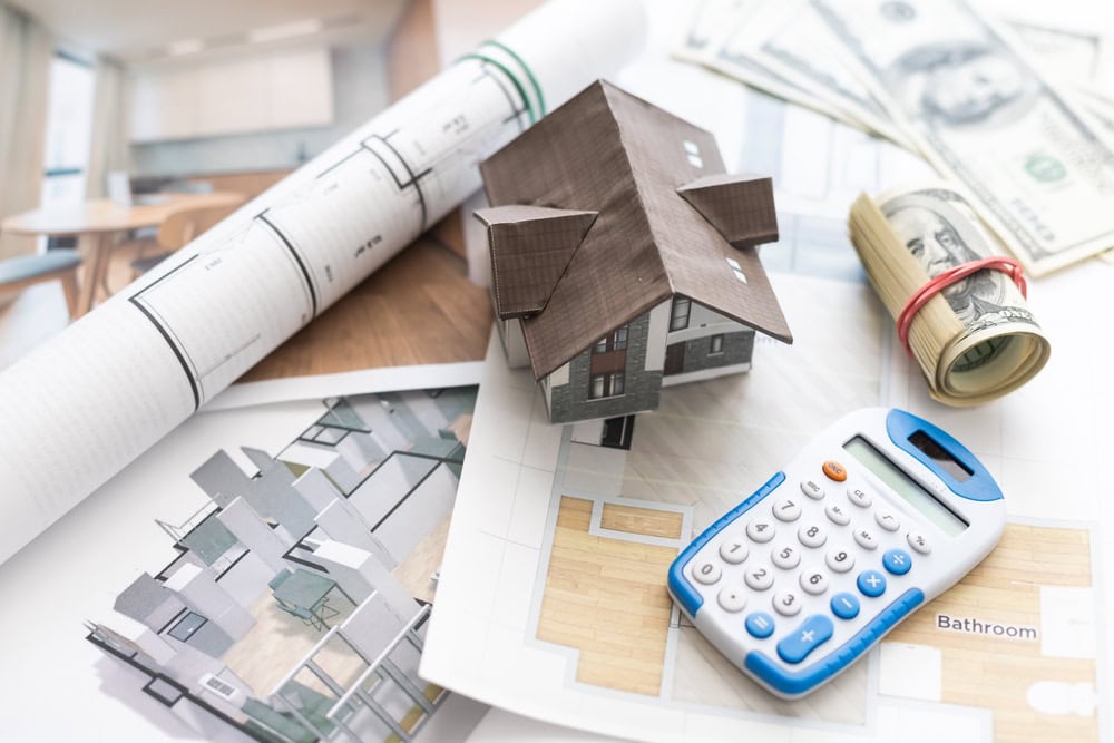 Planning your dream home: Blueprints, models, and finances come together in the home design and budgeting process.