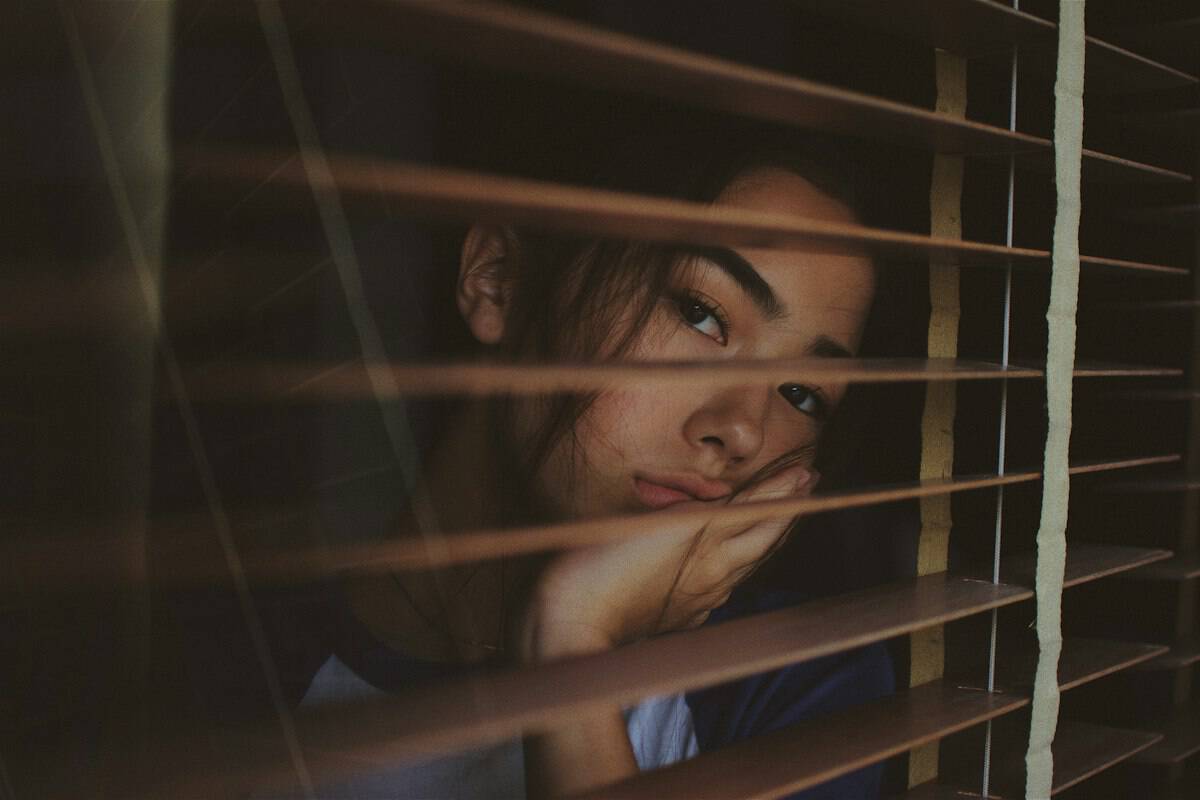 A homeowner standing beside a window